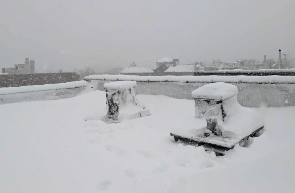Rooftop hives buried under the snow in the winter